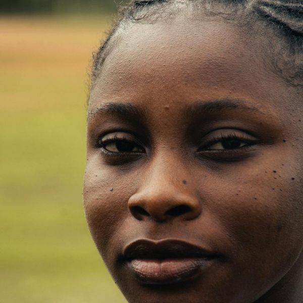 Close-up of a person's serene face with eyes closed, focusing on breathing.